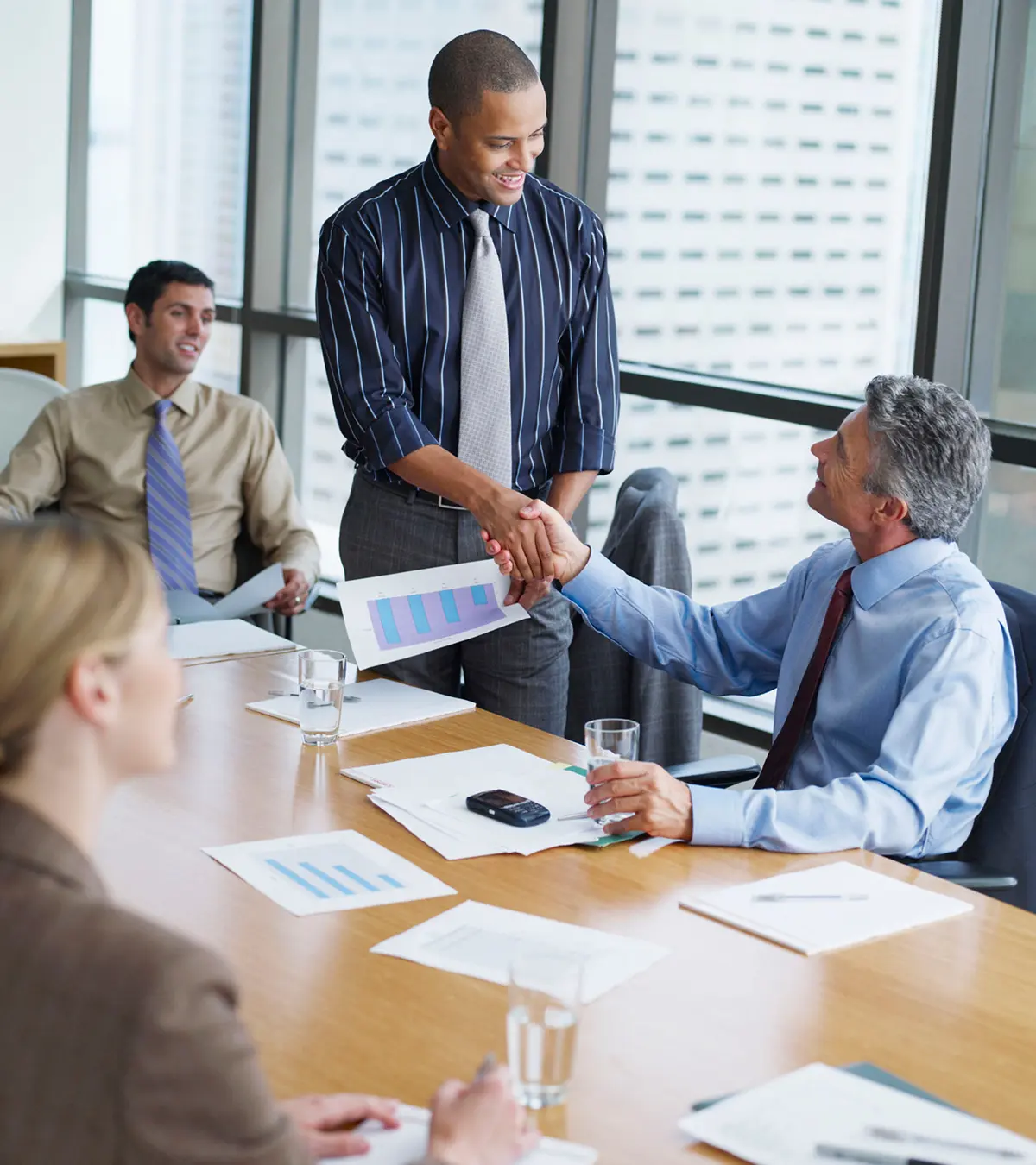 Colleagues shaking hands at meeting